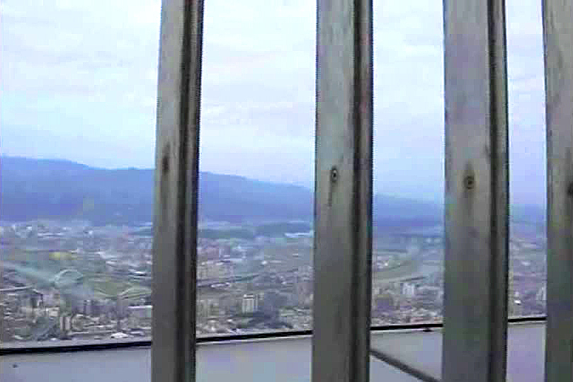 The view from the top of Taipei 101 looks out across the spooky, shroud-misted hills that surround the city.