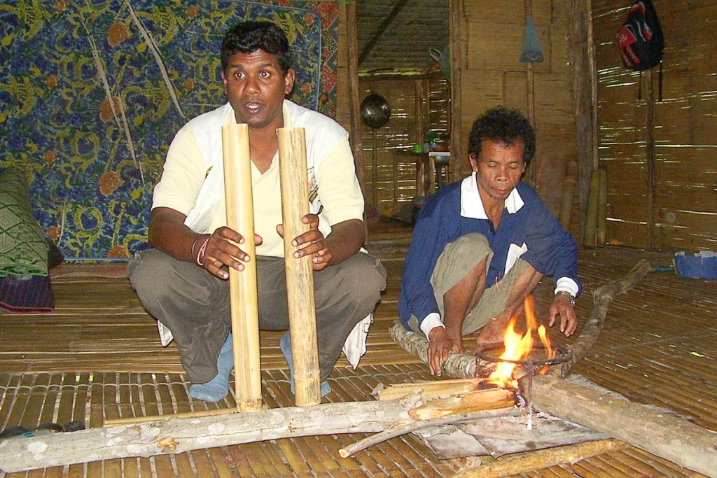 Kumar and a village elder give us a fire demonstration – inside the wooden hut.
