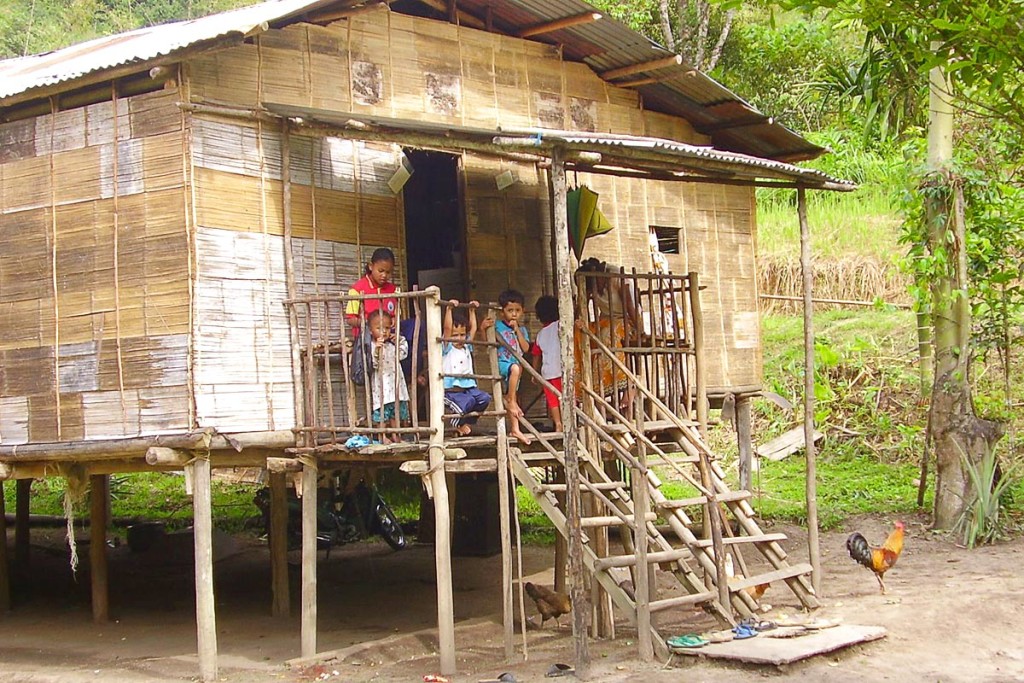 orang-asli-family-on-porch-village