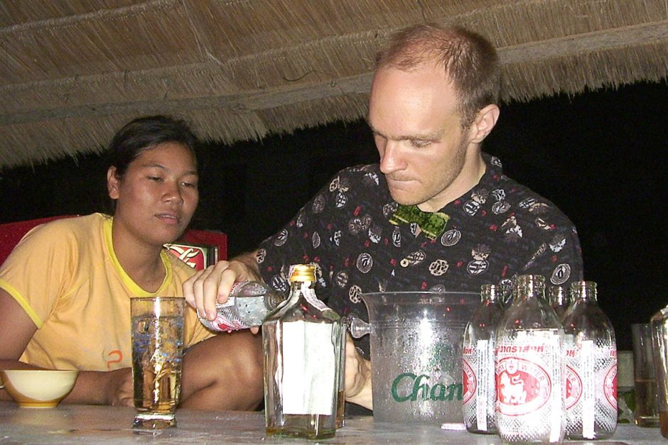 Aie looks on as I practice pouring whiskey into a glass.