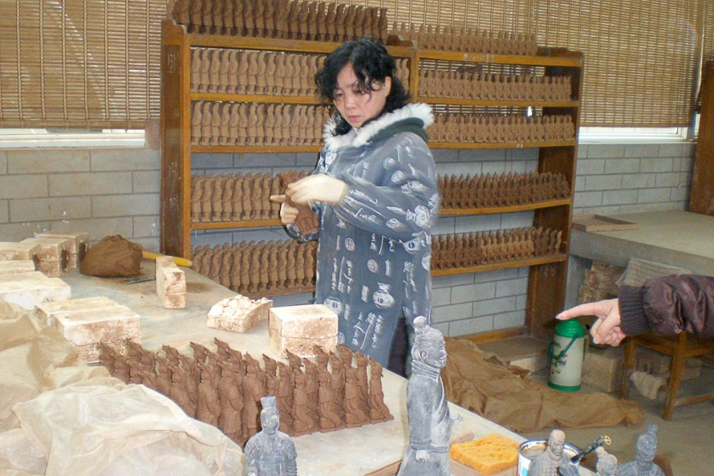Making figurines for the tourists, by hand.