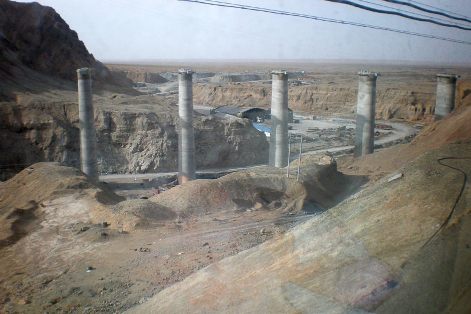 Unlikely construction project in the middle of the Qinghai desert, as seen through dingy train windows.