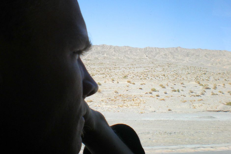 jeremy-looking-out-bus-window-qinghai-china-desert
