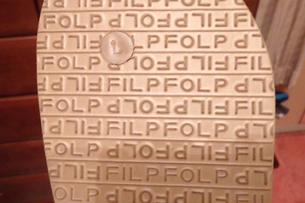 Flip-flops with "Filp Folp" logo, for showering in hostels