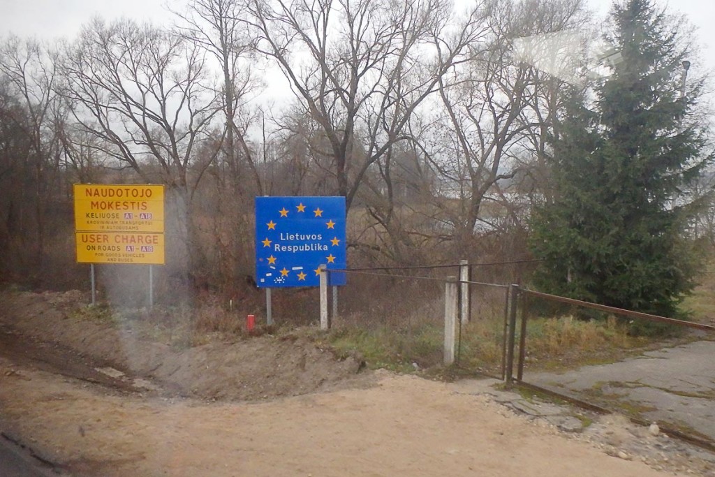 Welcome to Lithuania sign in the mist.