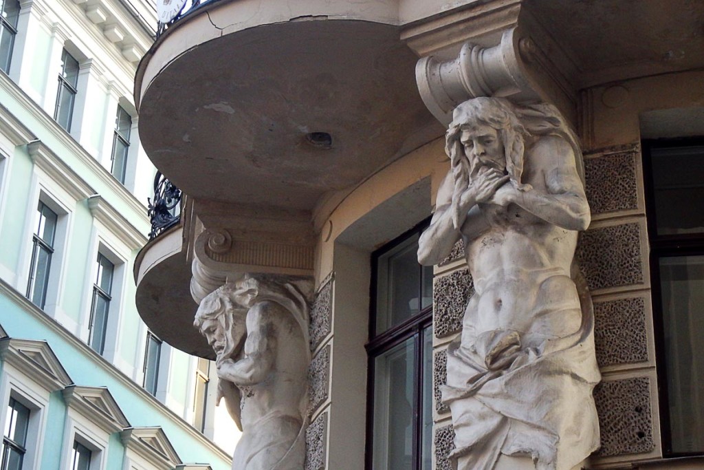 Strange statues on building façade in Rīga