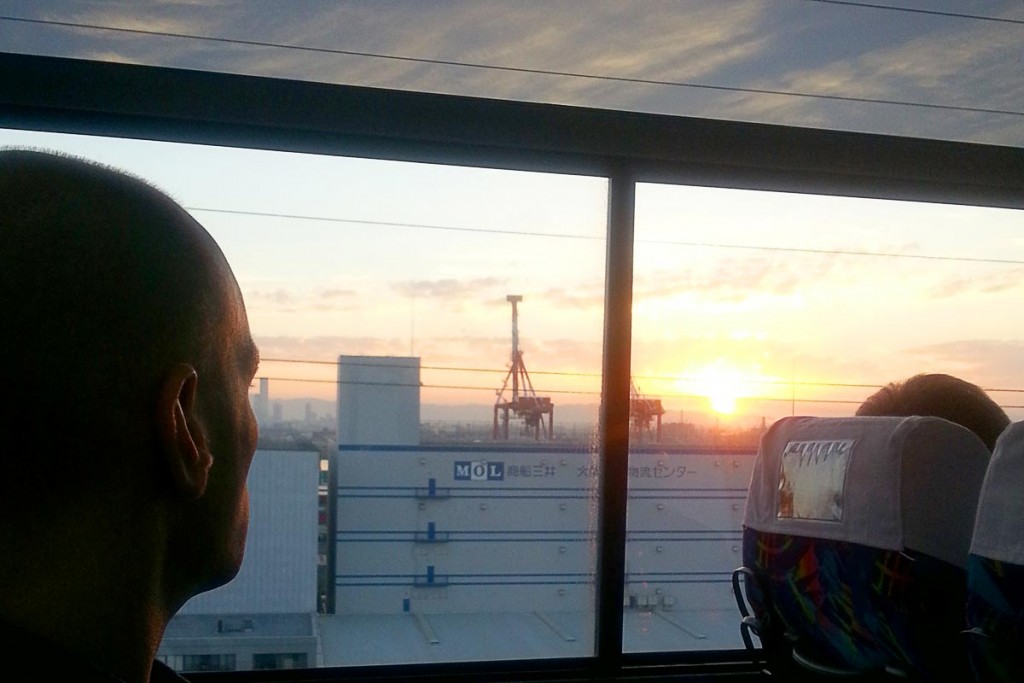 Gazing at the Osaka sunrise from the early morning bus to the airport.