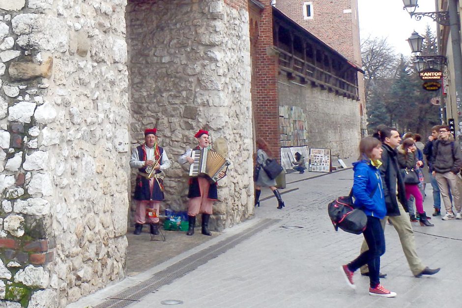 Musicians under the Florian Gate in old timey clothes.