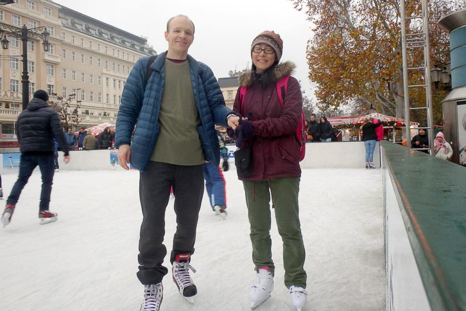 Us, posing on the ice skating rink. I was slipping and falling and complaining both before and after this placid-looking photo.