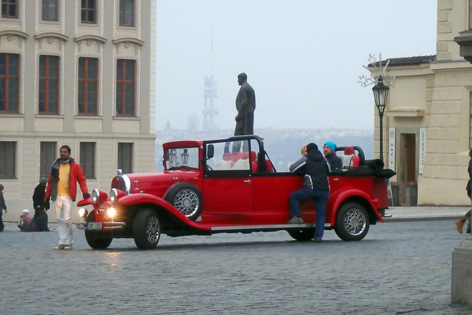 Red car and Prague cityscape