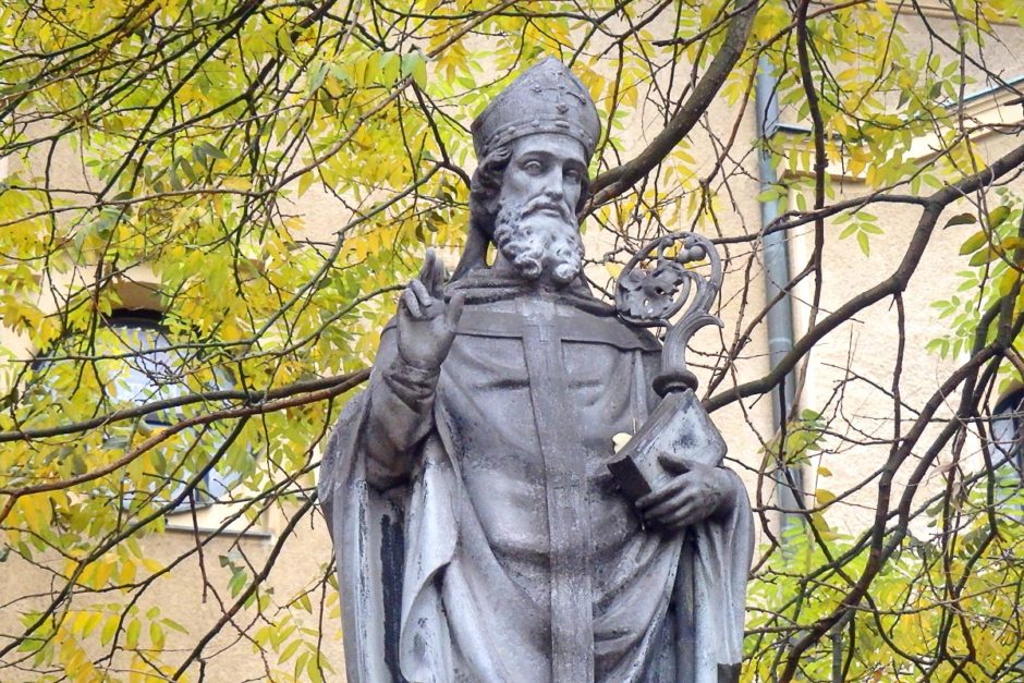 A statue and some trees at a church on our first walk through Warsaw.