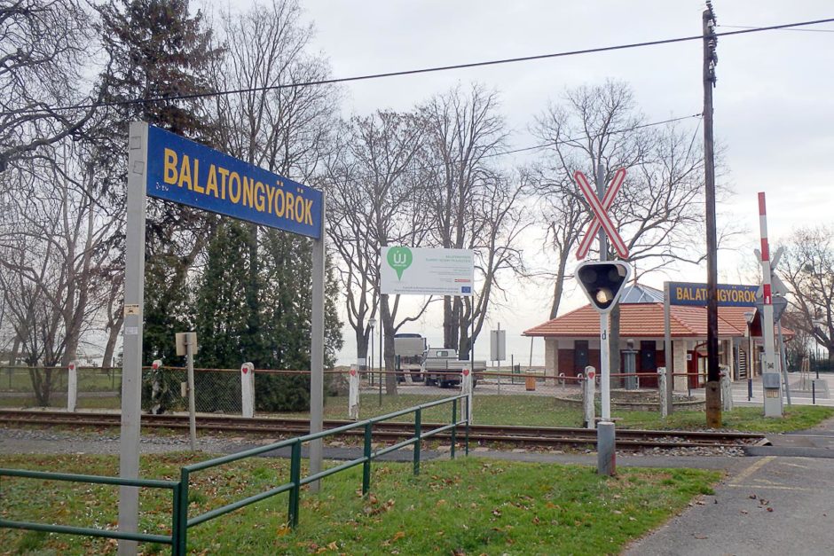 The sign at the train station for Balatongyörök, with Lake Balaton just visible behind.