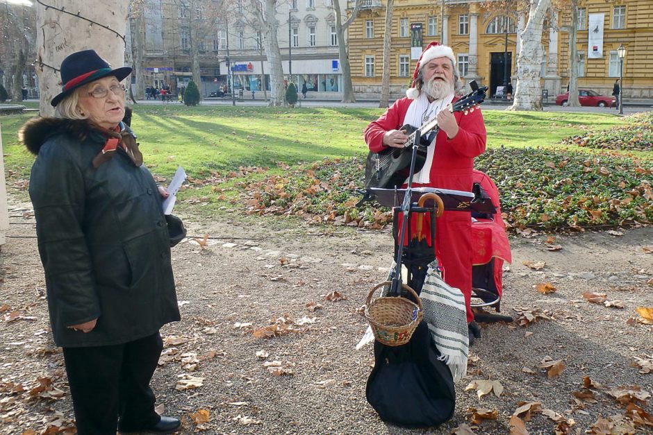Guy busking in a Santa suit. That's style!