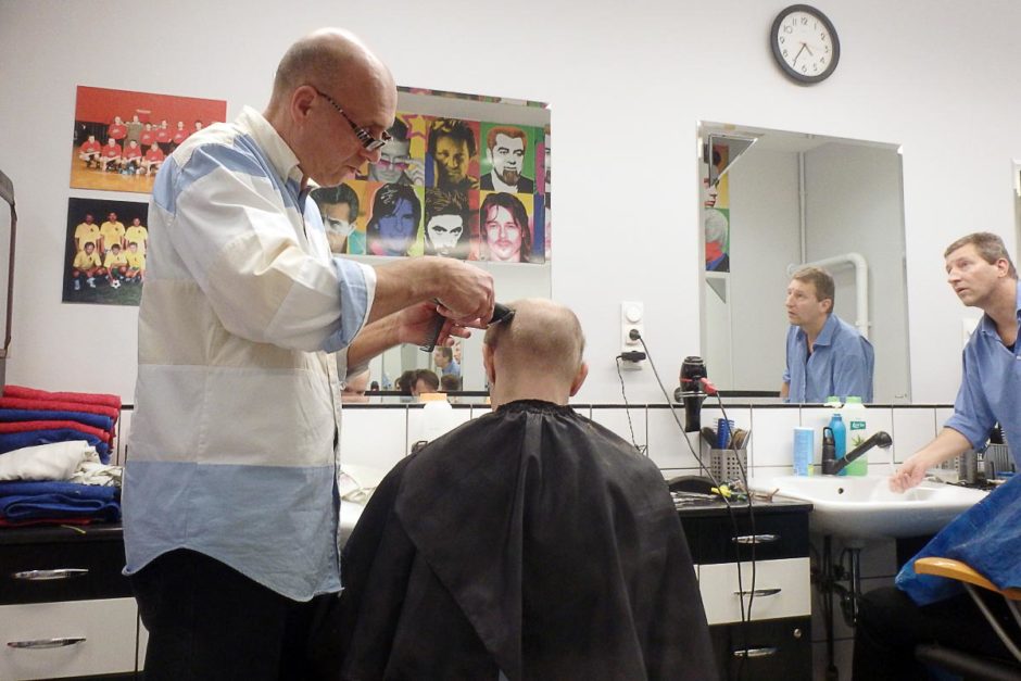 Sitting in the barber's chair for my first haircut of the trip.