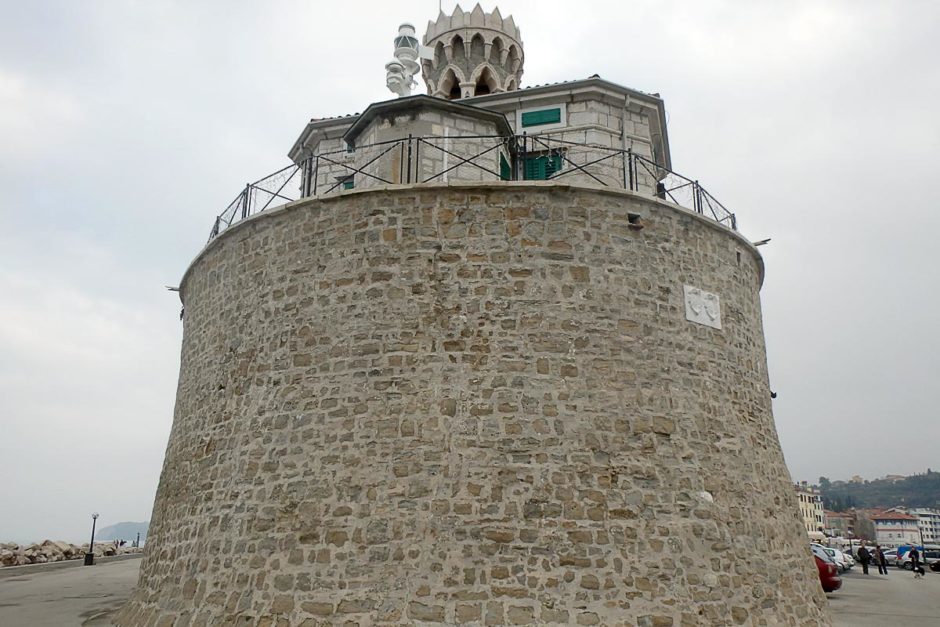 Round lighthouse building at the end of the Piran peninsula.