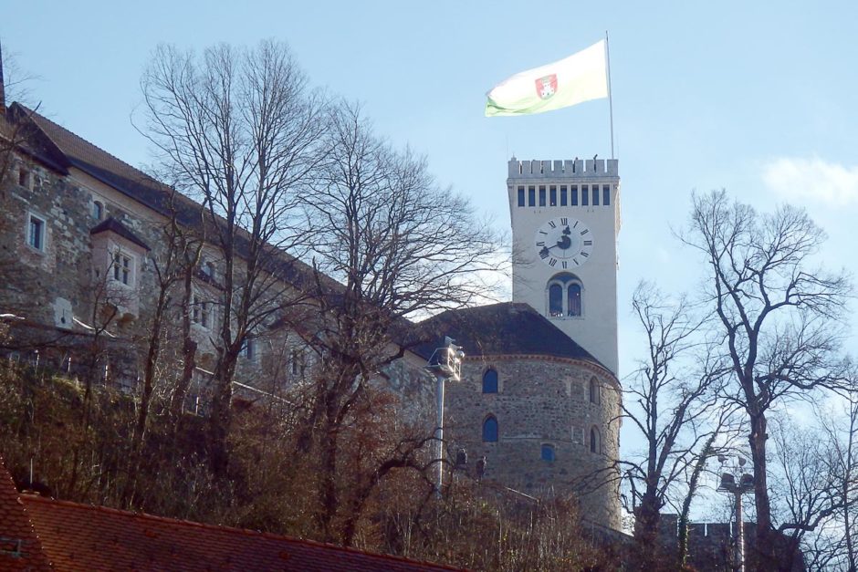 Ljubljana Castle, with its flag blowing in the wind, as seen from town.