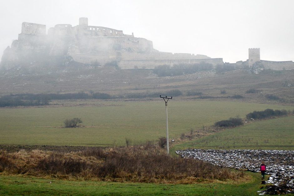 Masayo walking up the hill to Spiš Castle in the mist.