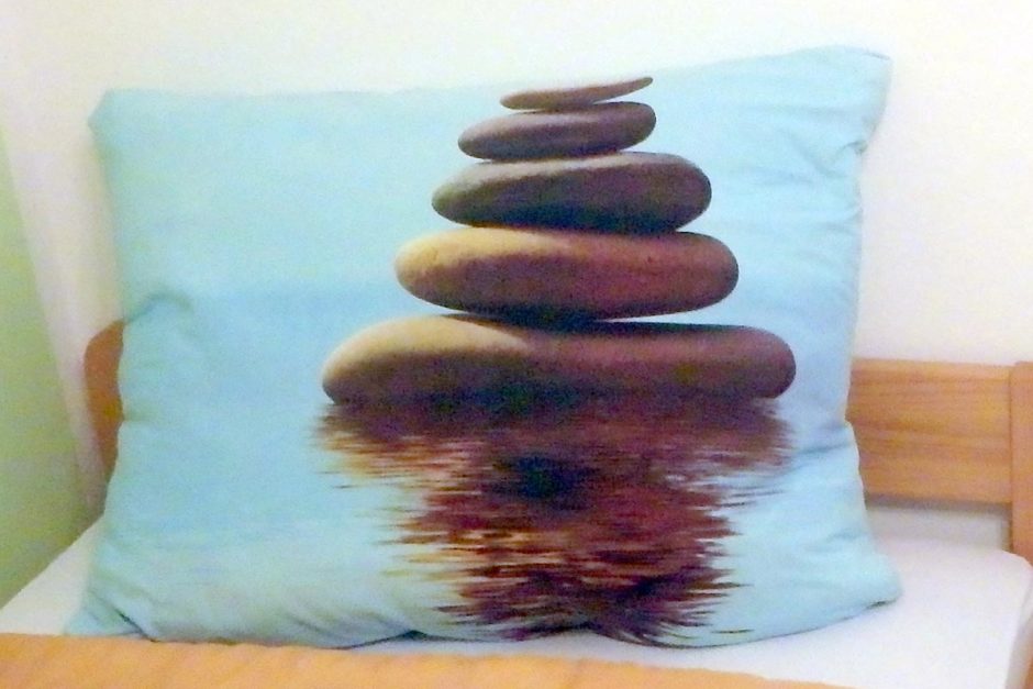 Pillowcases in our Pula room. What's the first thing you see? Because for me, it wasn't a pile of rocks, I'll tell you that.