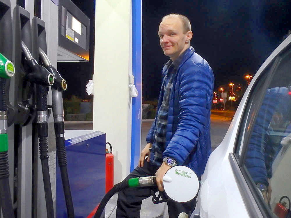 Filling up the gas tank before returning the rental car.