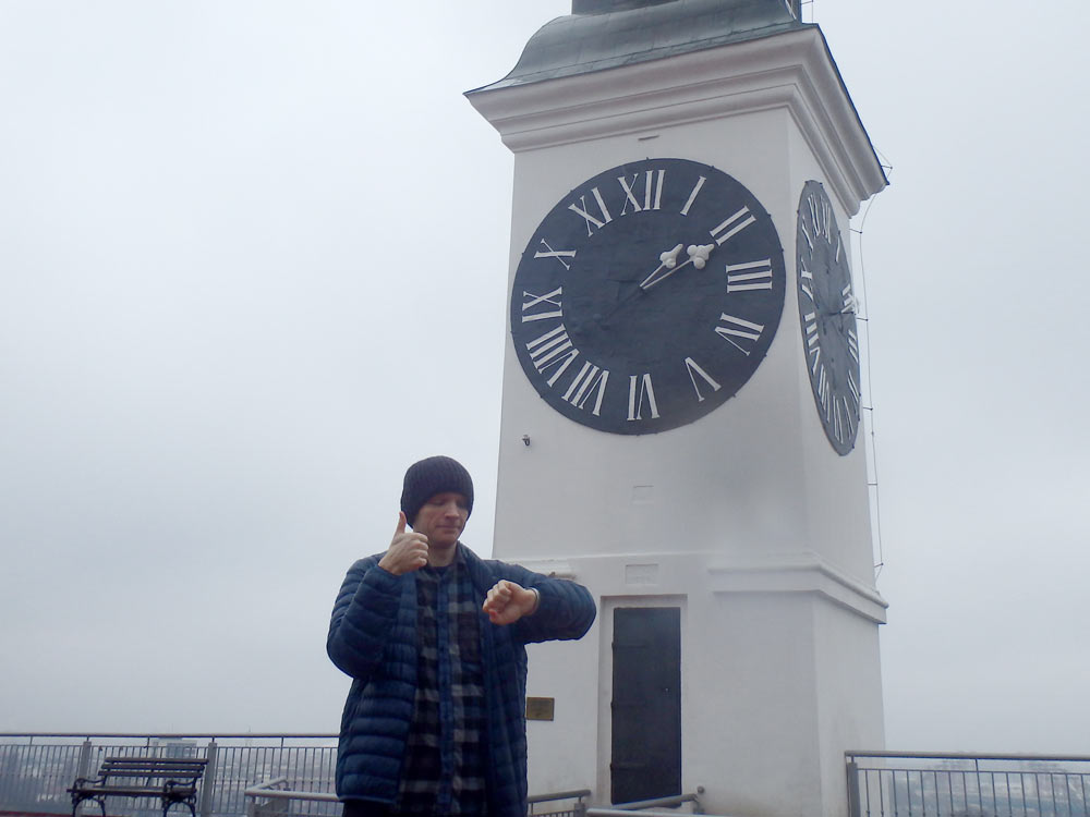 Checking my watch against the Novi Sad clock tower