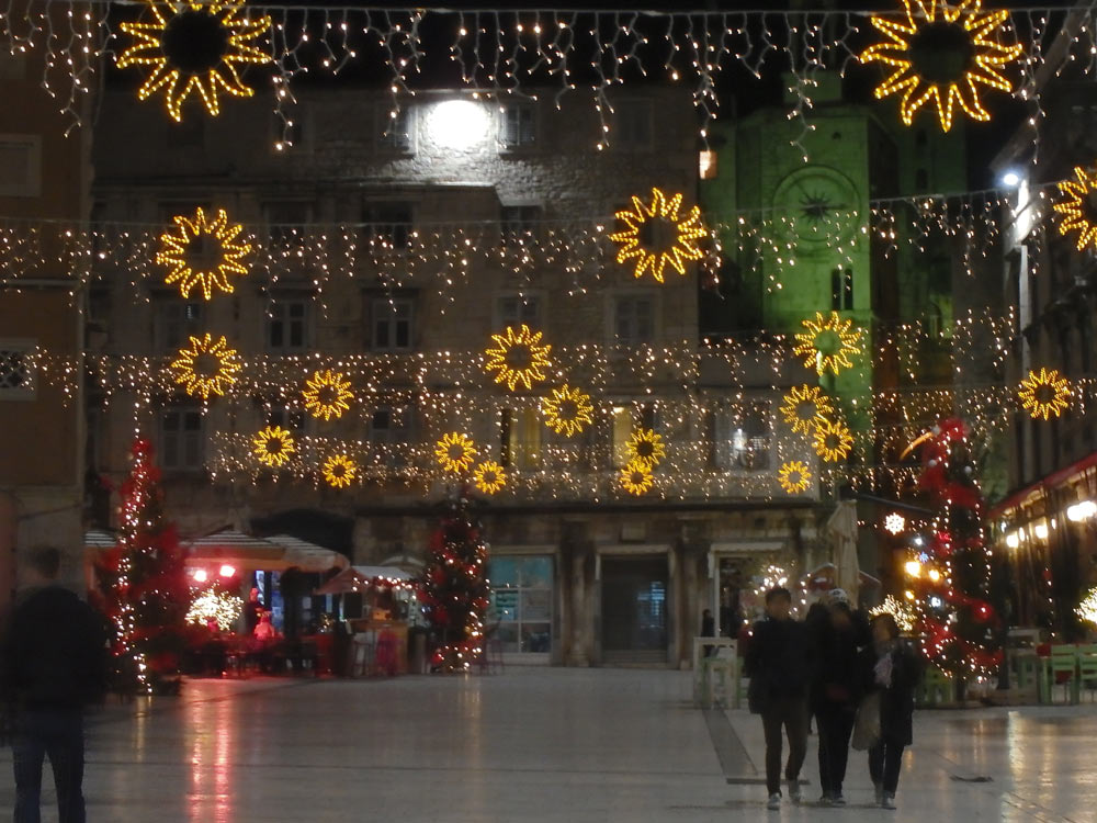 A square in Split decorated with lights and flowers.