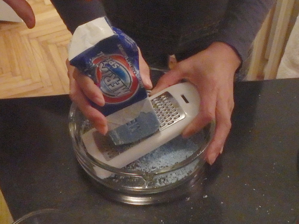Grinding a bar of soap in a cheese grater for the greater good.
