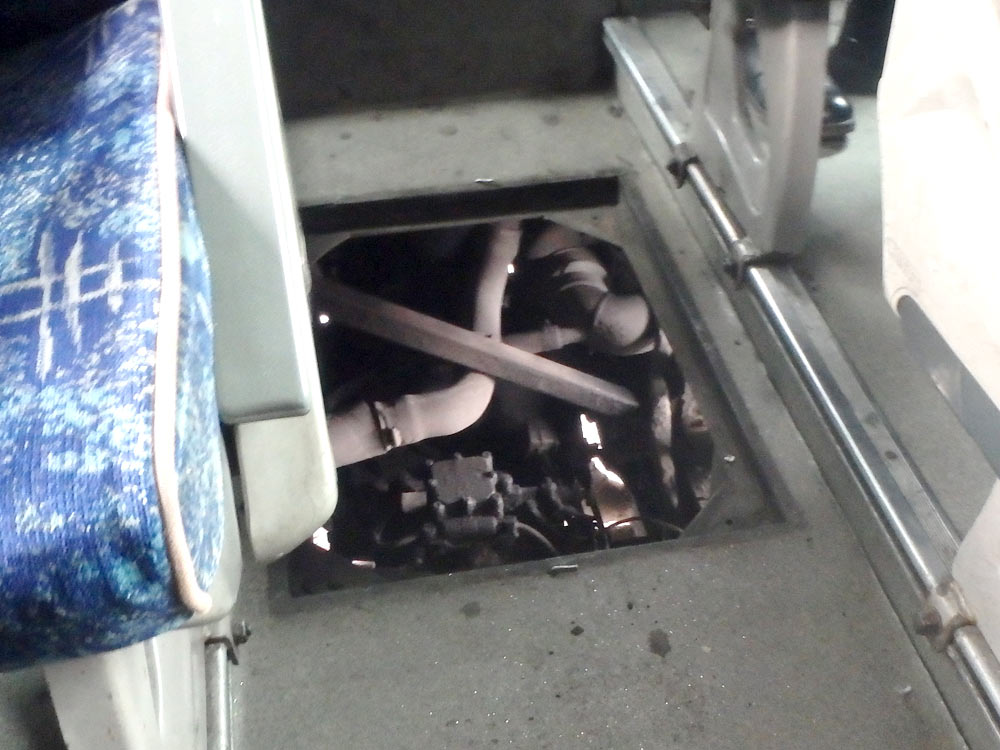 Hole in the floor of the Serbian bus, where the staff was trying to fix whatever was wrong.