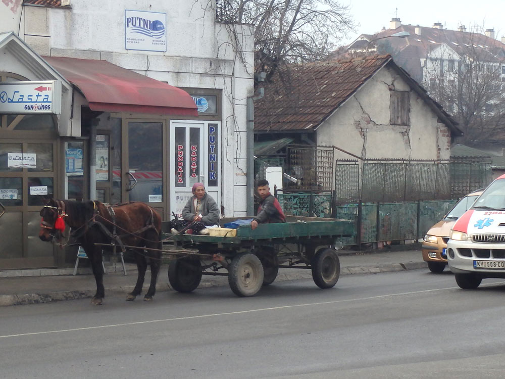 A horse-drawn cart on the street in front of the bus station in Kraljevo