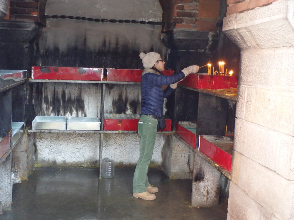 Masayo lighting a candle at Žiča Monastery