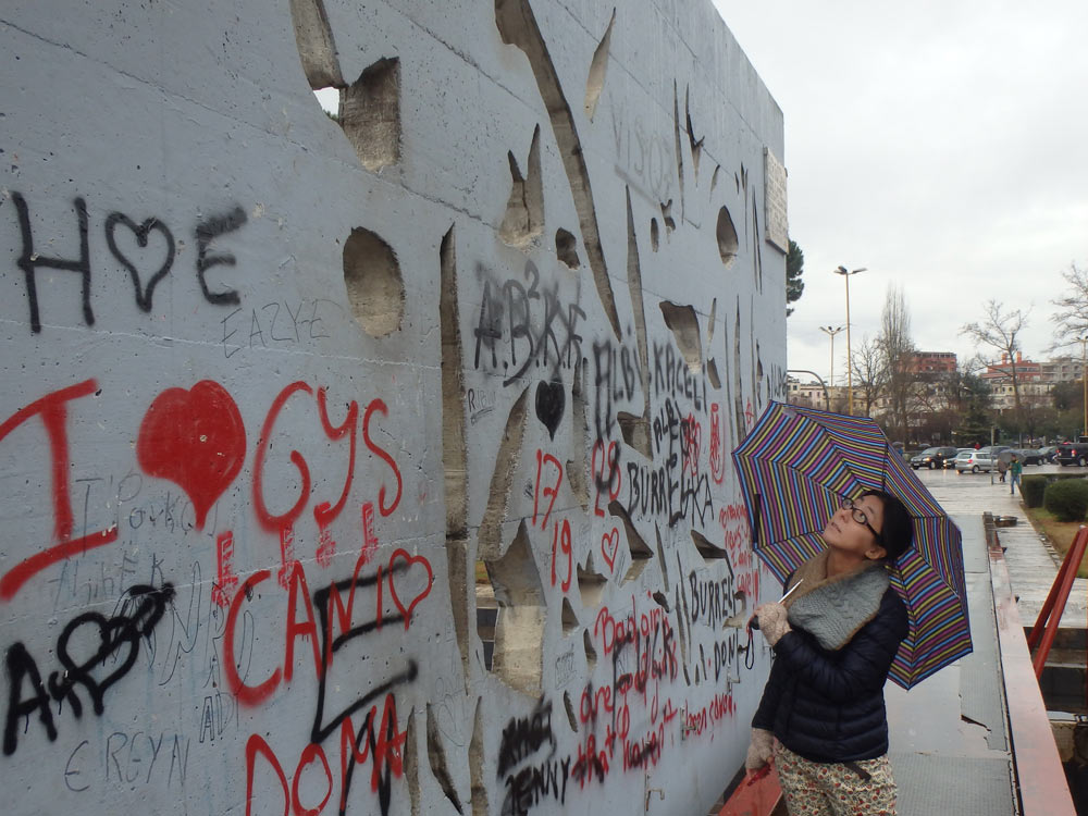 Masayo looking at some graffiti outside the pyramid