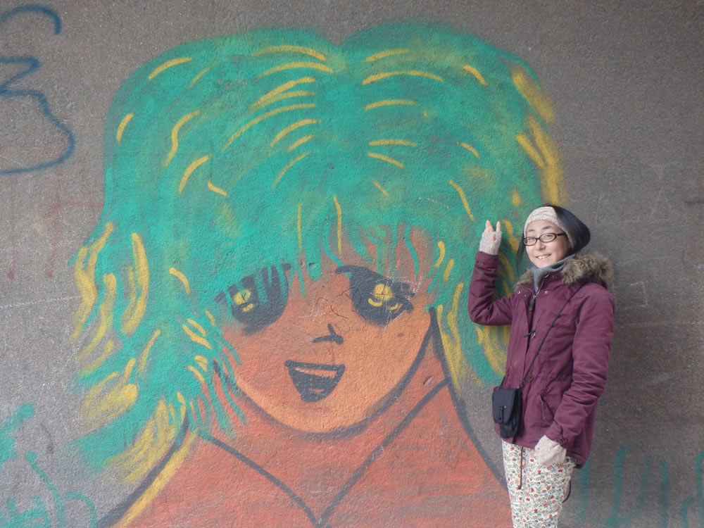 Masayo with anime-type graffiti outside our apartment