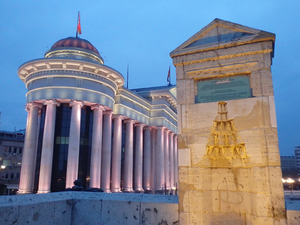 National Archaeological Museum in Skopje at dusk, plus a part of the bridge in the foreground