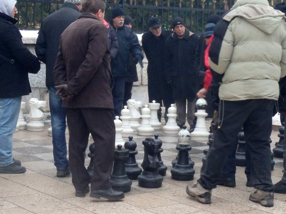 Old men with giant chess pieces on a Sarajevo street