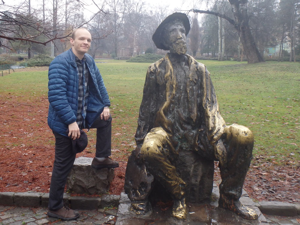 Posing with a statue in a Novi Sad park