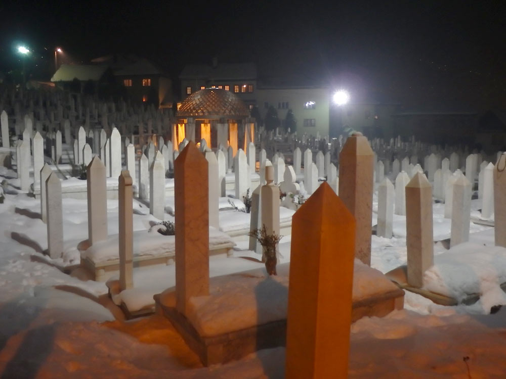 Snowy Sarajevo cemetery at night