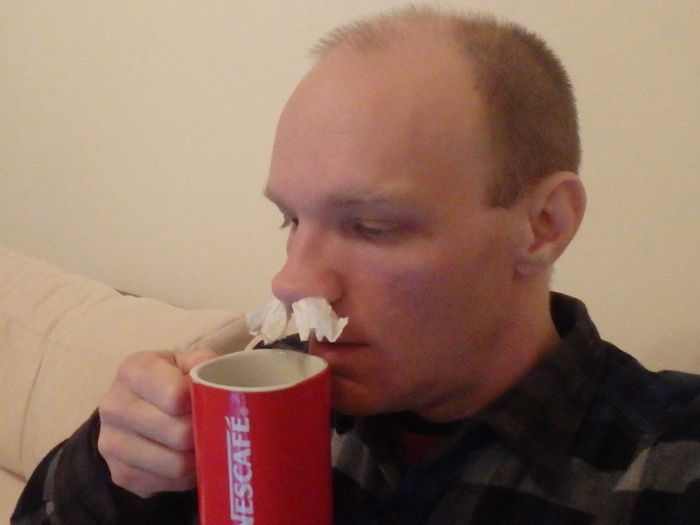 Drinking a hot lemon drink with tissue in either nostril.