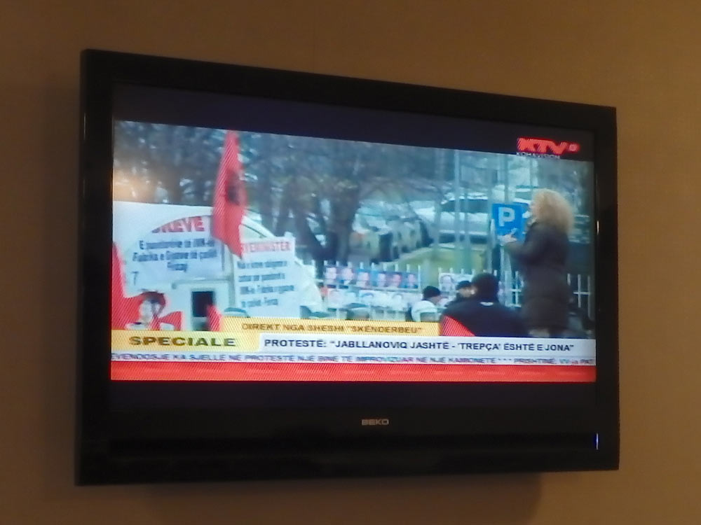 TV news in Prishtina showing a "protestë" rally and a woman speaking. After the violence of Saturday, was this going to be ok? Seemed calm enough.