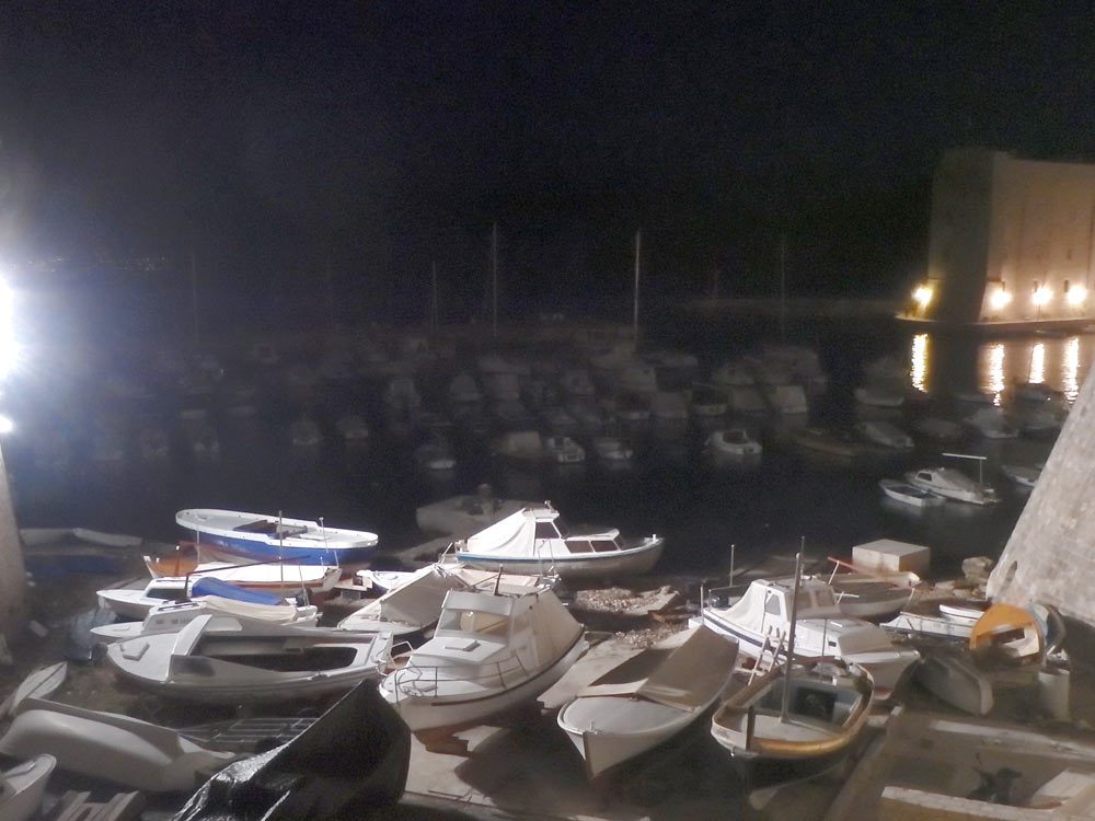 Boats in the harbor in Dubrovnik at night