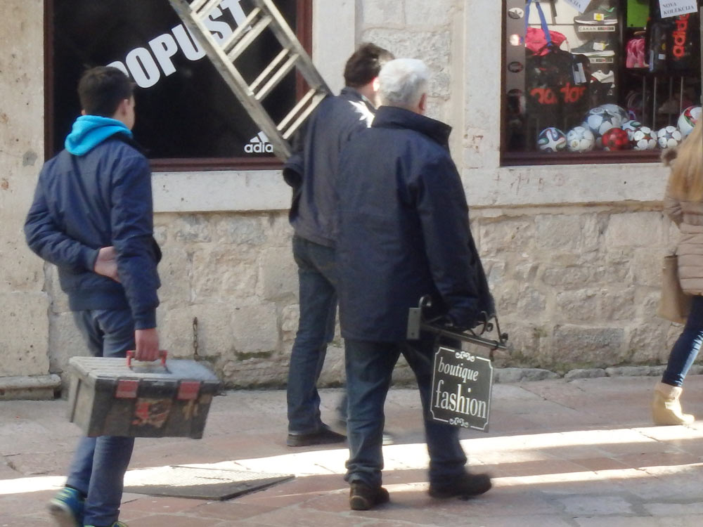 Guys carrying beauty shop equipment in Kotor