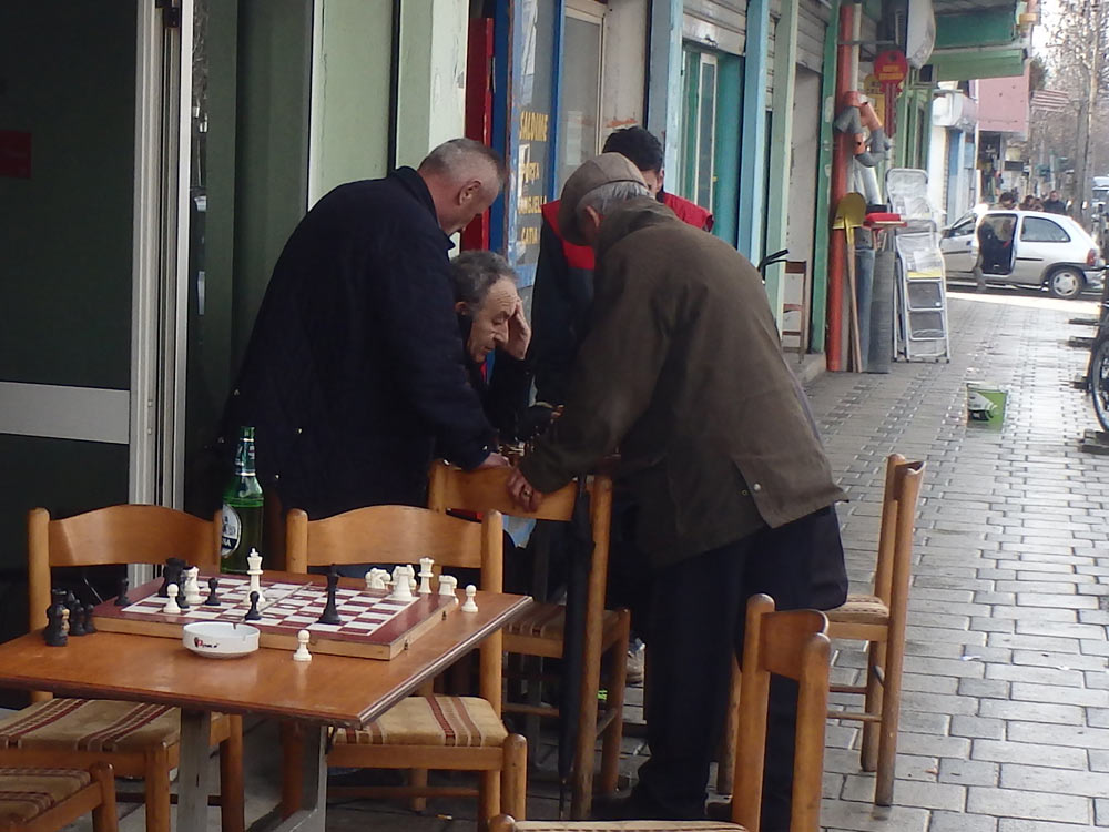 Guys playing chess on a Tirana street