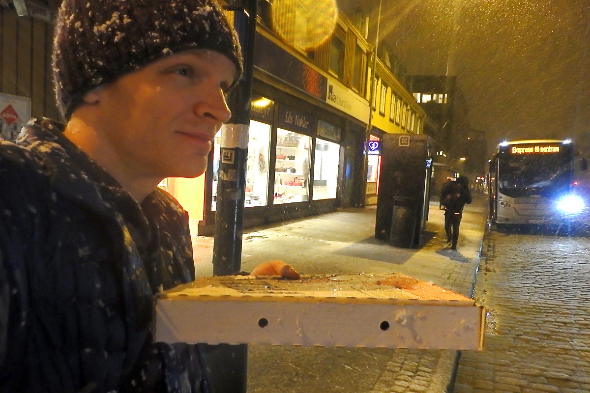 Carrying pizza through a Norwegian snowstorm.
