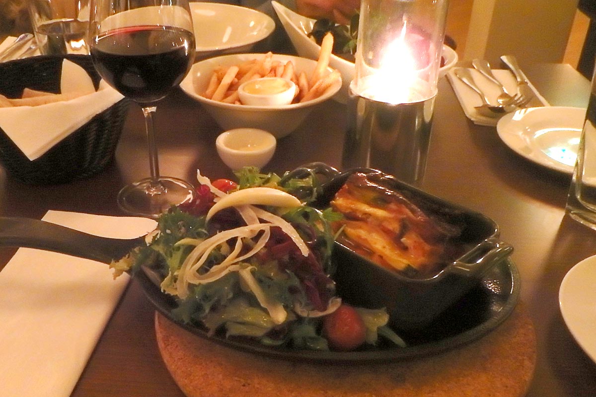 Lasagna, wine and bread. And fries.