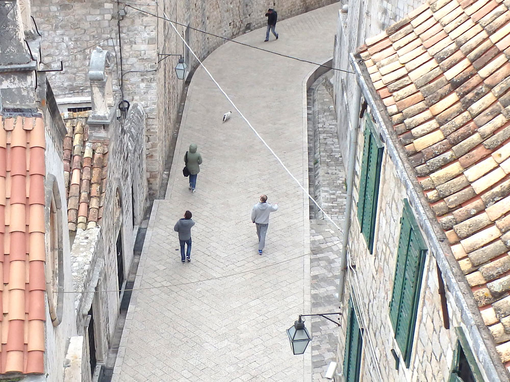 Looking down at a part of Old Town from the wall. If you look closely you can see a cat leading the people down the path.