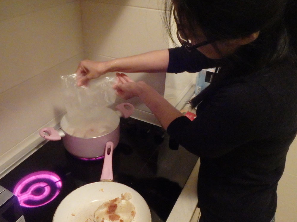 Masayo making fish soup for dinner back in the room