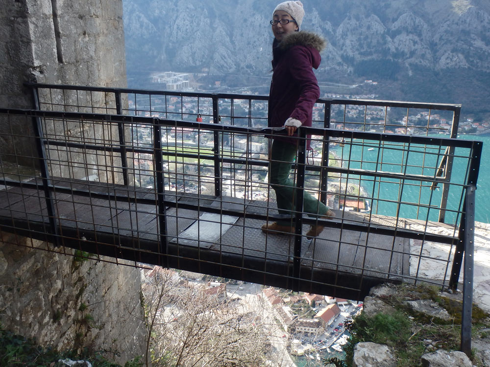 Masayo walking over the scary Kotor fortress entrance walkway