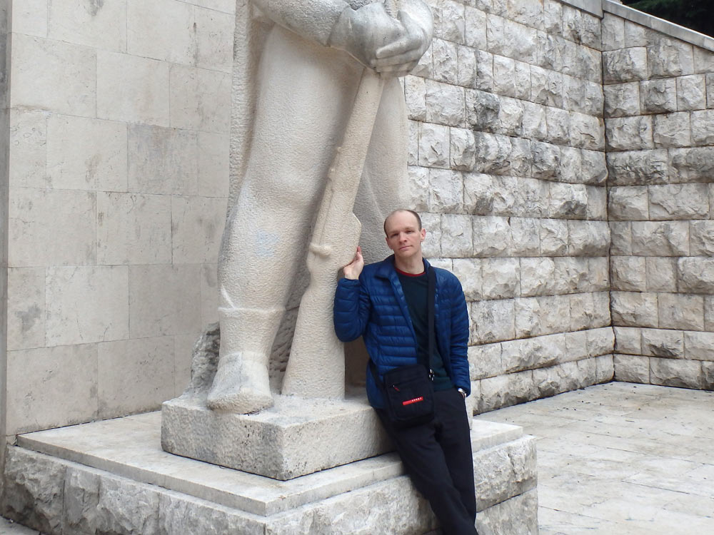 With one of the two big statues next to the WW2 monument