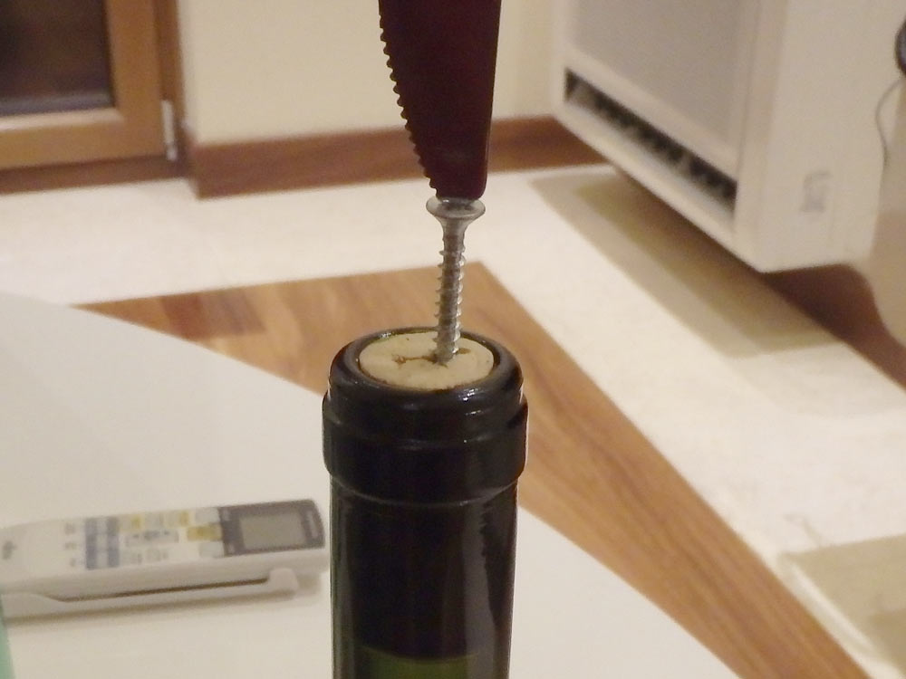Putting the screw into the wine cork. Nice idea, but it didn't work