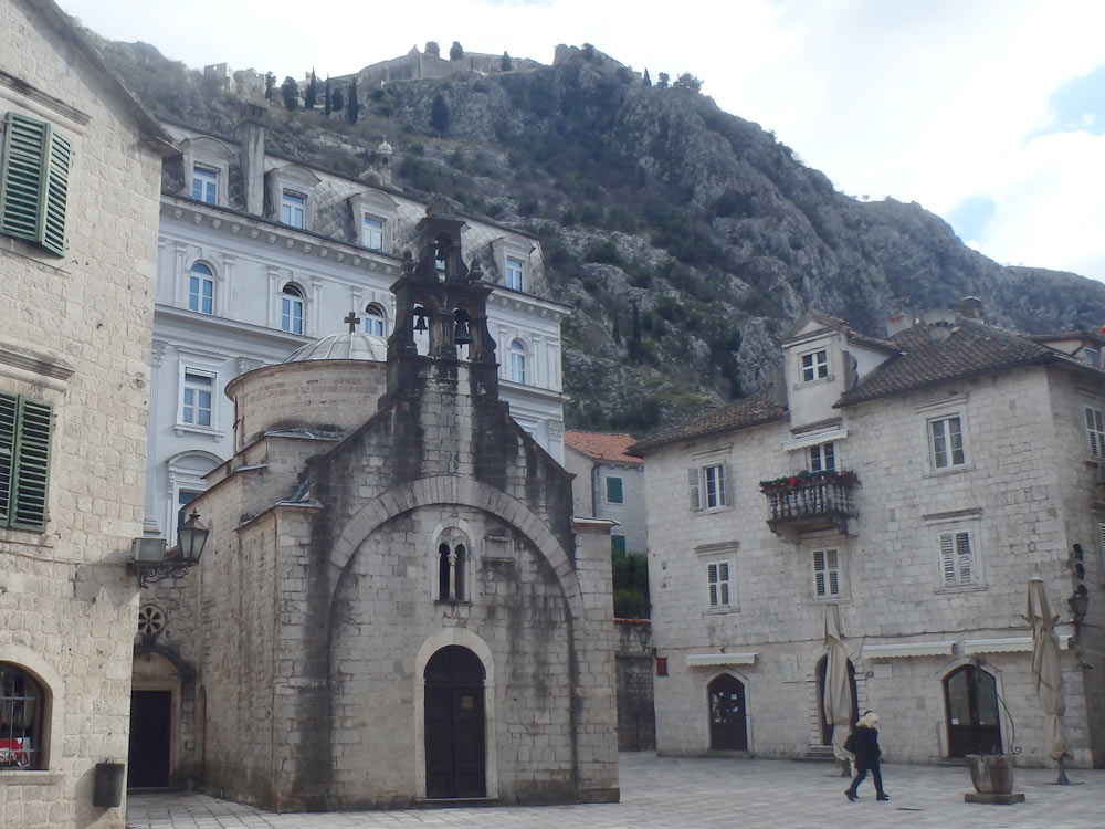 Small church in Kotor Old Town. Look at those walls snaking along the steep hill behind it — our destination!