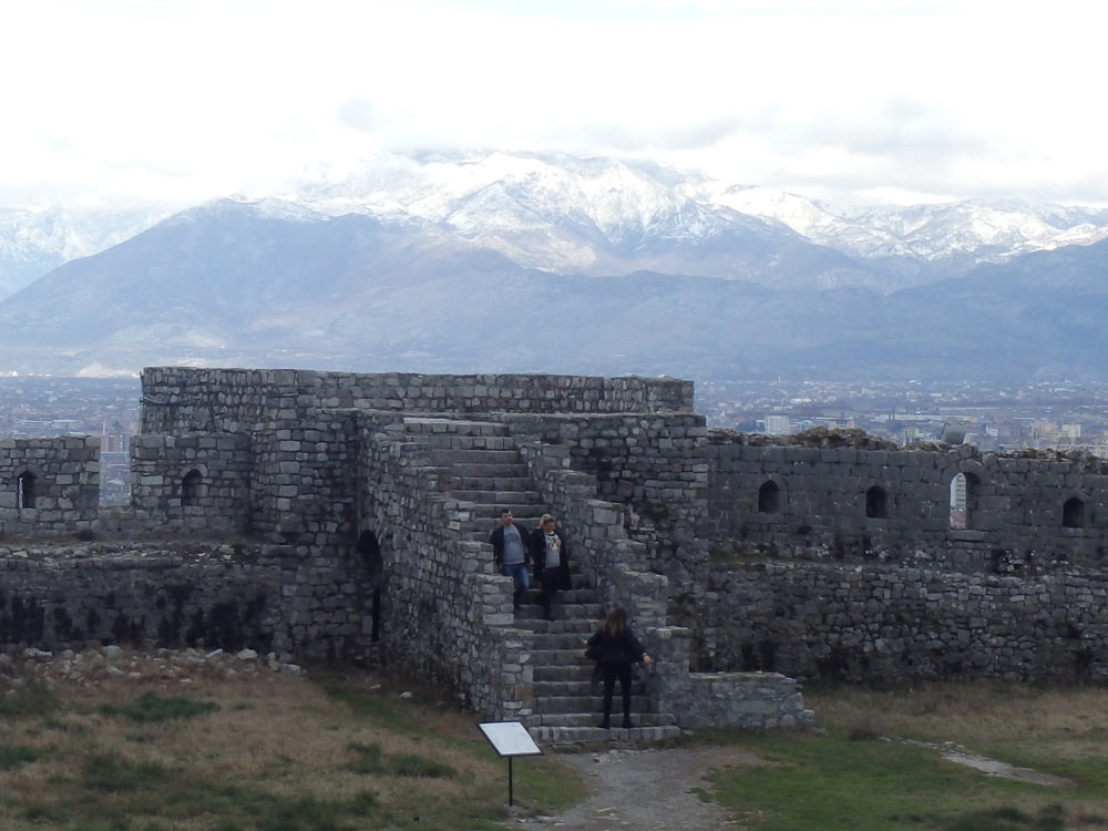 Stairs at Rozafa Castle with snowy mountains in the distance