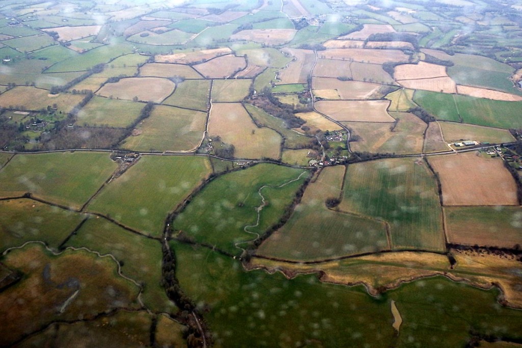 green-fields-southern-england-plane-window